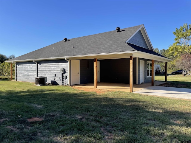 back of house featuring cooling unit, a patio area, and a lawn