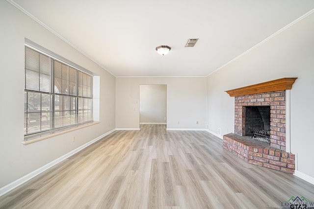 unfurnished living room with ornamental molding, light hardwood / wood-style floors, and a brick fireplace