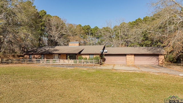 view of front of property with a garage and a front yard