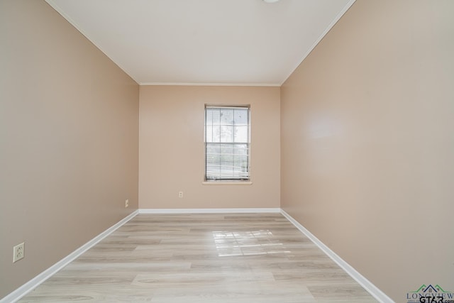 spare room featuring crown molding and light wood-type flooring