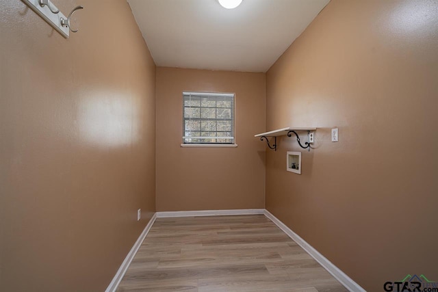 laundry area with hookup for a washing machine and light hardwood / wood-style floors