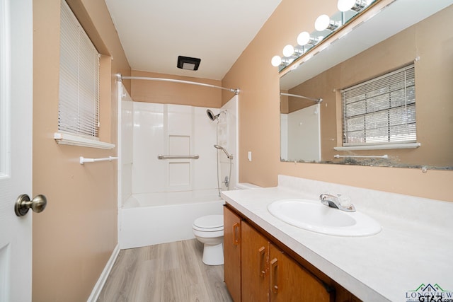 full bathroom with shower / tub combination, vanity, toilet, and hardwood / wood-style floors