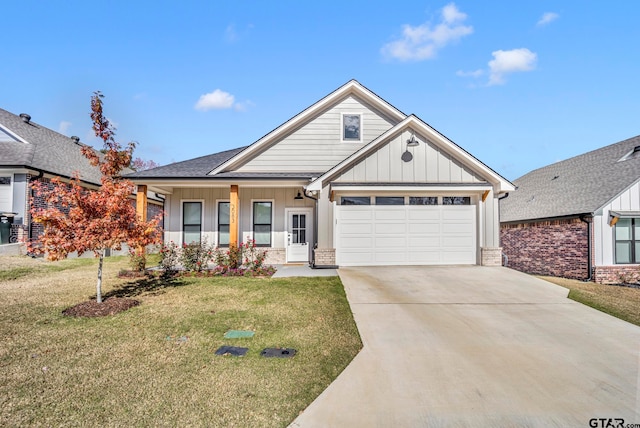 view of front of property featuring covered porch, a front yard, and a garage