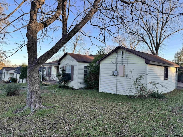 view of property exterior featuring a lawn