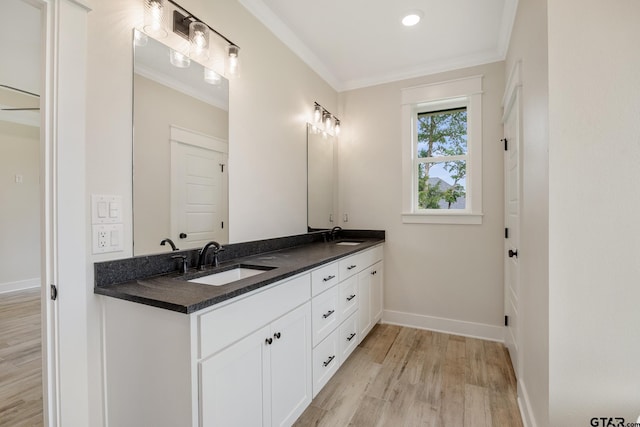 14738 Woodland Creek Dr, Tyler, TX 75706 - bathroom featuring wood finished floors, double vanity, baseboards, and crown molding