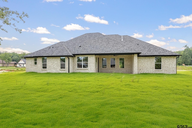 14738 Woodland Creek Dr, Tyler, TX 75706 - rear view of house featuring a lawn, a ceiling fan, roof with shingles, and brick siding