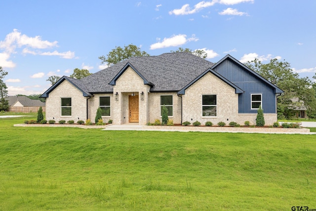 14738 Woodland Creek Dr, Tyler, TX 75706 - view of front of house featuring a front lawn, brick siding, board and batten siding, and roof with shingles