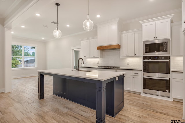 14738 Woodland Creek Dr, Tyler, TX 75706 - kitchen with appliances with stainless steel finishes, a sink, decorative backsplash, white cabinets, and ornamental molding