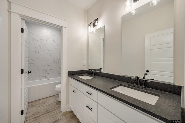 14738 Woodland Creek Dr, Tyler, TX 75706 - full bathroom featuring toilet, double vanity, wood finished floors, and  shower combination
