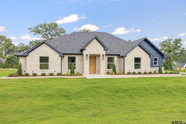 14738 Woodland Creek Dr, Tyler, TX 75706 - view of front facade with brick siding, a front lawn, board and batten siding, and roof with shingles