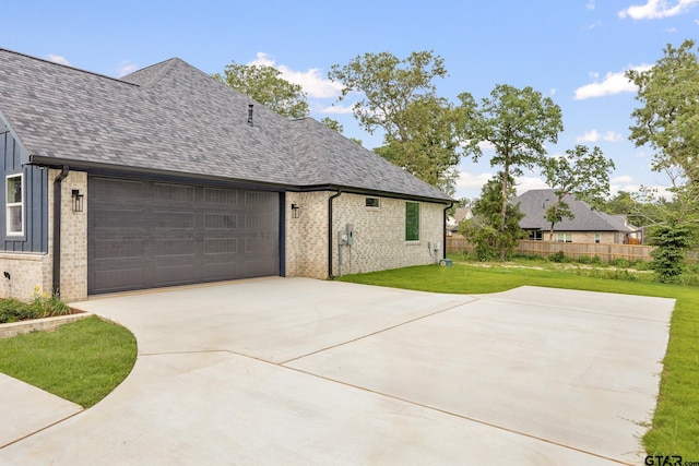 14738 Woodland Creek Dr, Tyler, TX 75706 - view of side of property featuring brick siding, driveway, a garage, and roof with shingles