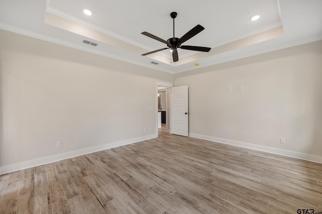 14738 Woodland Creek Dr, Tyler, TX 75706 - unfurnished room with a raised ceiling, ornamental molding, a ceiling fan, light wood finished floors, and baseboards