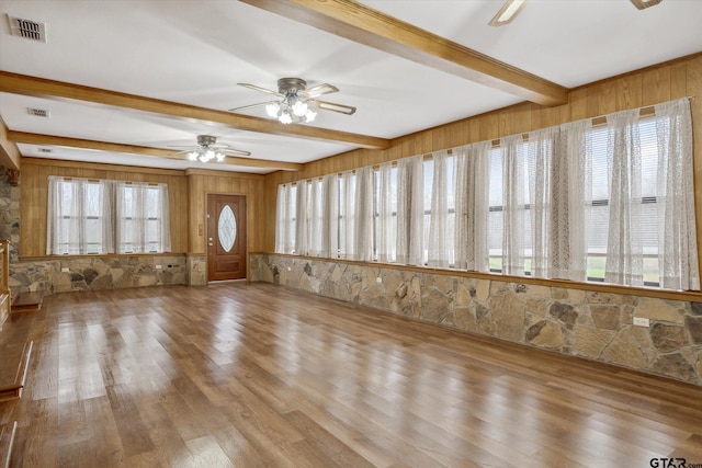 interior space featuring wood finished floors, a healthy amount of sunlight, and visible vents