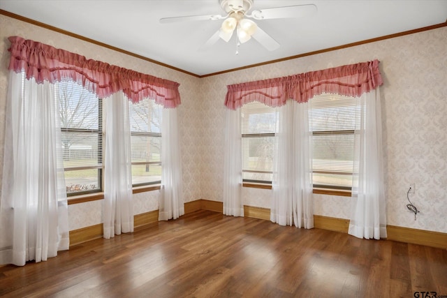 unfurnished dining area featuring wood finished floors, crown molding, and wallpapered walls