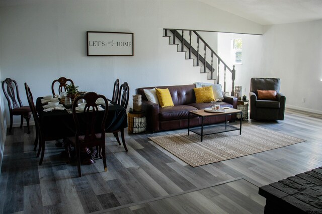 living room featuring hardwood / wood-style floors and vaulted ceiling