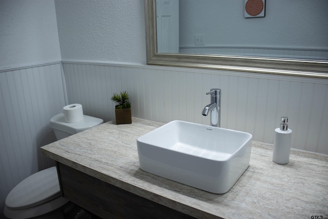 bathroom featuring vanity and toilet