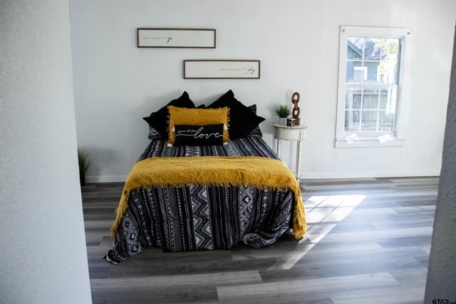 bedroom with hardwood / wood-style flooring