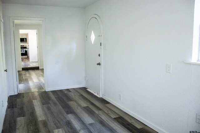 spare room featuring dark hardwood / wood-style floors