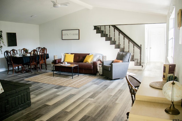 living room featuring lofted ceiling with beams, wood-type flooring, and ceiling fan