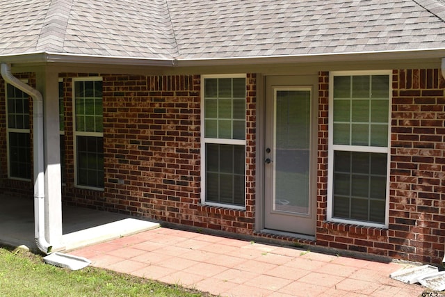 17387 Cherokee Trl, Flint, TX 75762 - entrance to property featuring a patio area, a shingled roof, and brick siding