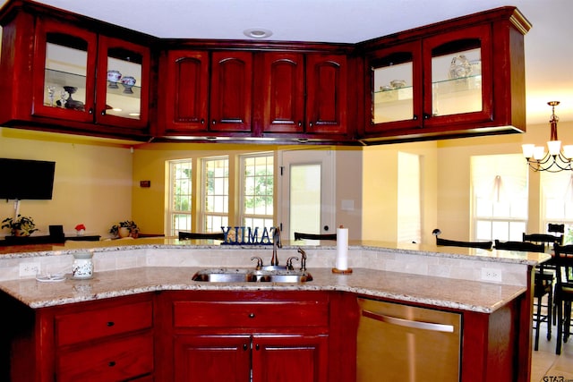 17387 Cherokee Trl, Flint, TX 75762 - kitchen with stainless steel dishwasher, a sink, light stone countertops, and reddish brown cabinets