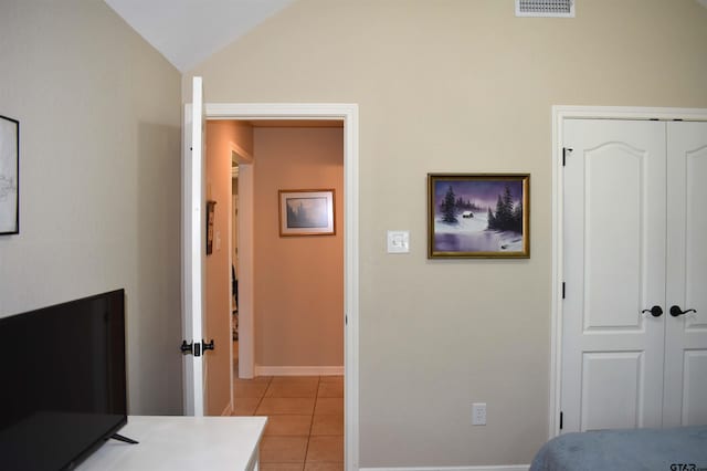 17387 Cherokee Trl, Flint, TX 75762 - bedroom featuring light tile patterned floors, vaulted ceiling, a closet, and baseboards