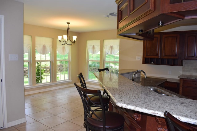 17387 Cherokee Trl, Flint, TX 75762 - kitchen with light tile patterned floors, light stone countertops, and a breakfast bar