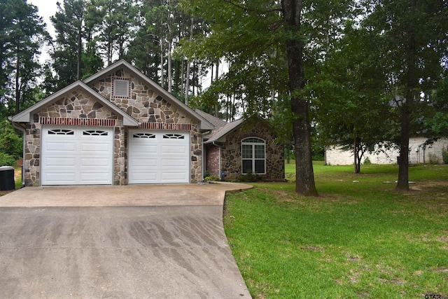17387 Cherokee Trl, Flint, TX 75762 - view of front facade with stone siding, driveway, an attached garage, and a front lawn