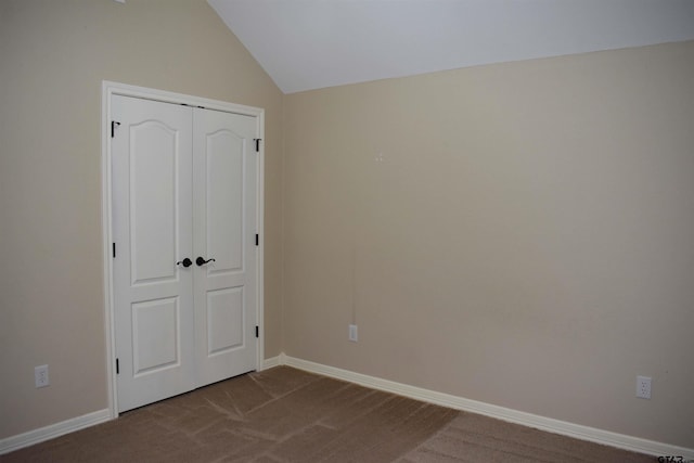 17387 Cherokee Trl, Flint, TX 75762 - unfurnished bedroom with dark colored carpet, vaulted ceiling, baseboards, and a closet