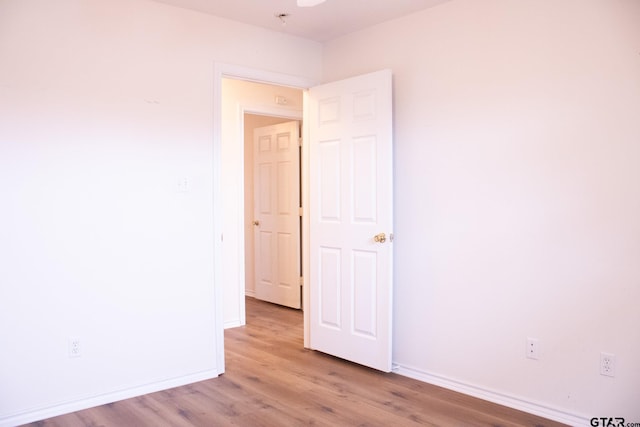 empty room with light hardwood / wood-style floors