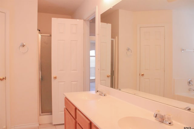 bathroom featuring vanity, tile patterned floors, and walk in shower