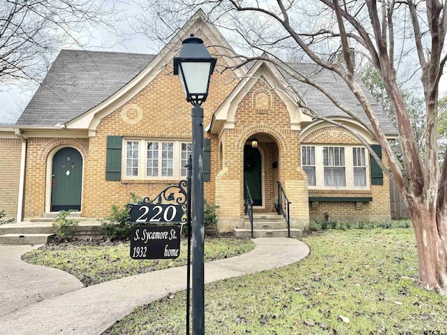 tudor house with a front yard