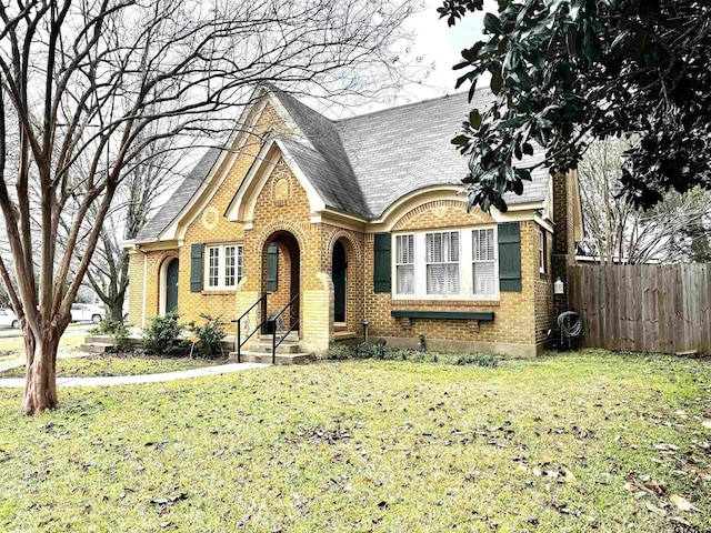 english style home with a front lawn