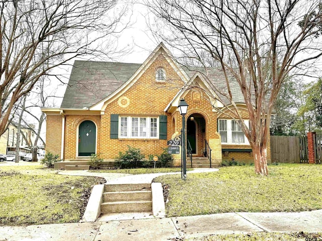 tudor home with a front yard