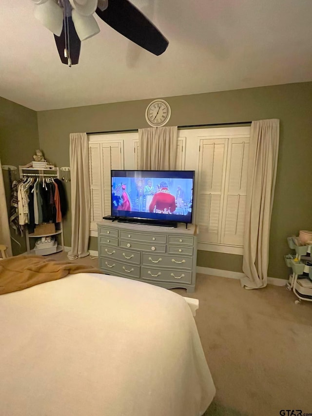 bedroom with ceiling fan and light carpet