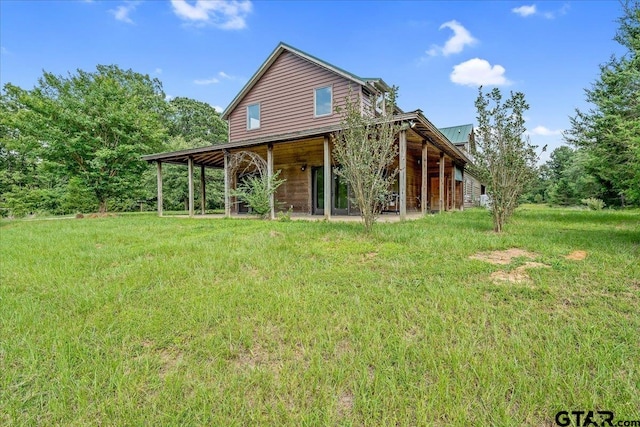 back of house with a lawn