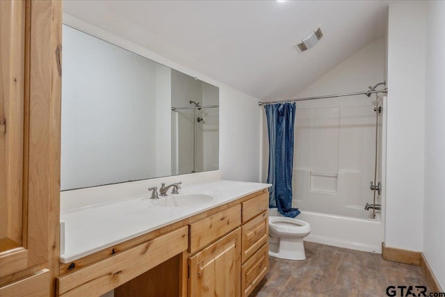 full bathroom with shower / tub combo, wood-type flooring, vanity, toilet, and vaulted ceiling