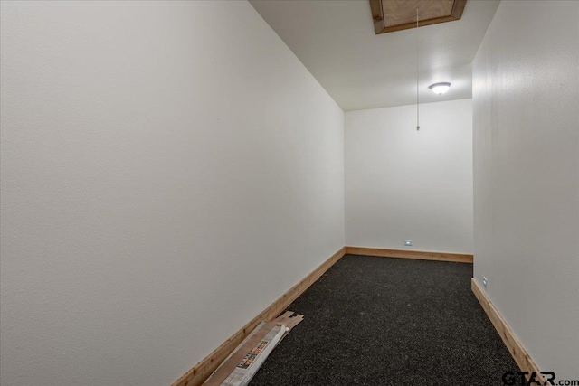 unfurnished room featuring dark carpet