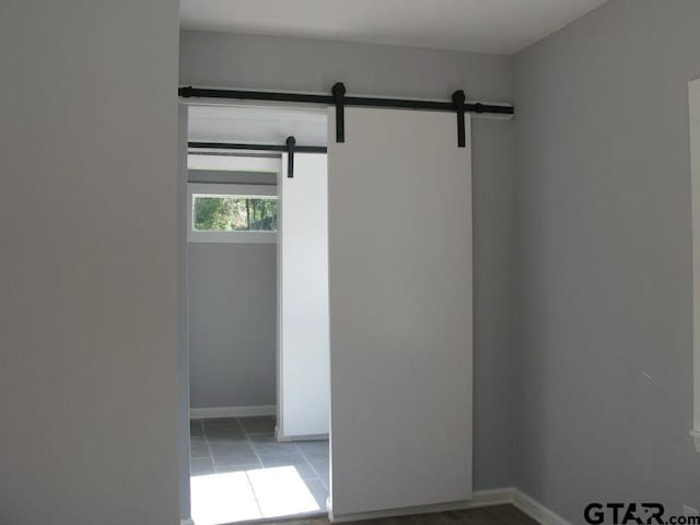 spare room featuring a barn door