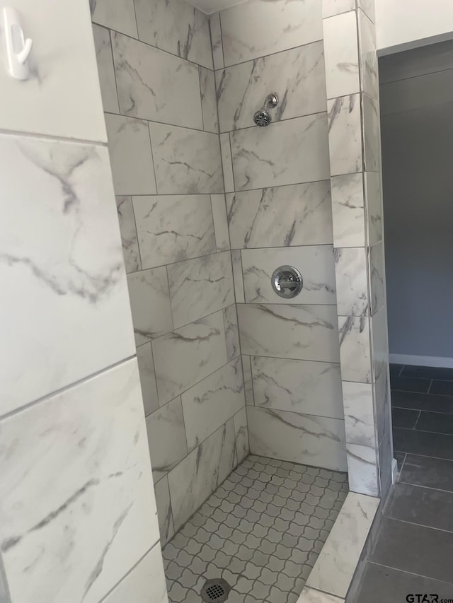 bathroom featuring tile patterned floors and tiled shower