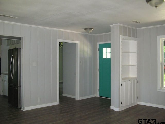 interior space with dark wood-type flooring and ornamental molding