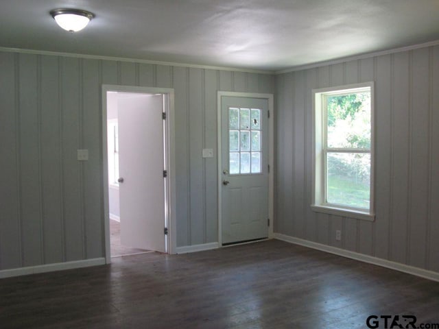 entryway with ornamental molding and dark hardwood / wood-style floors