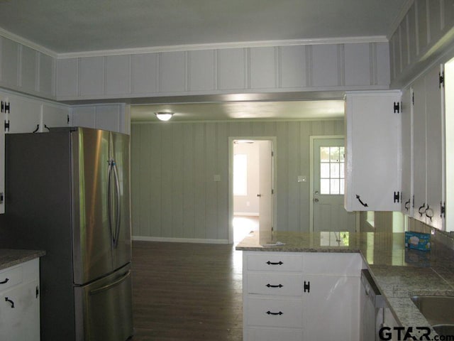 kitchen with white cabinetry, light stone counters, appliances with stainless steel finishes, crown molding, and dark hardwood / wood-style flooring