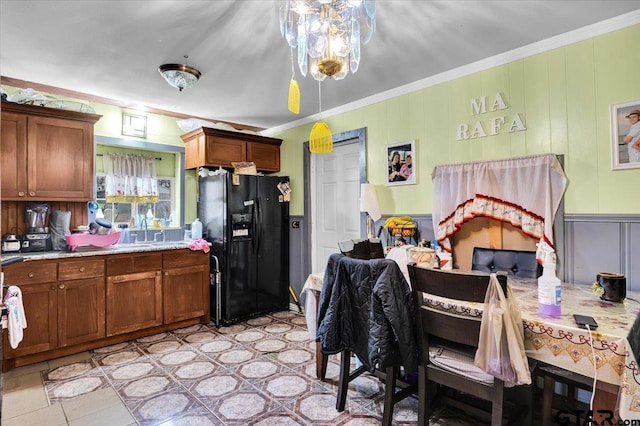 kitchen featuring brown cabinets, light countertops, and black fridge