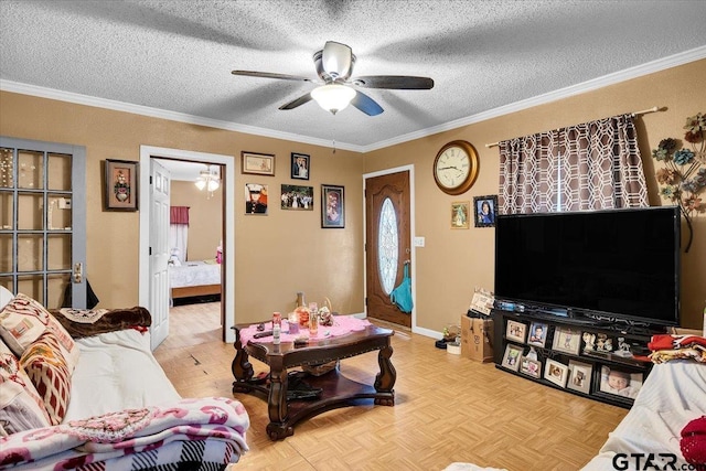 living room featuring a ceiling fan, baseboards, ornamental molding, and a textured ceiling