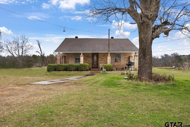 view of front of house featuring a front yard and brick siding