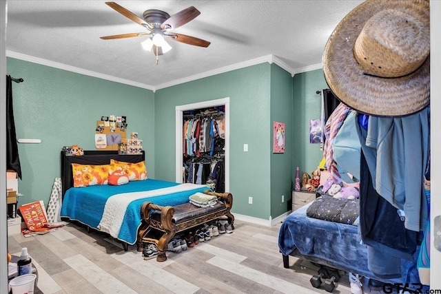 bedroom featuring light wood-style flooring, a textured ceiling, baseboards, and crown molding