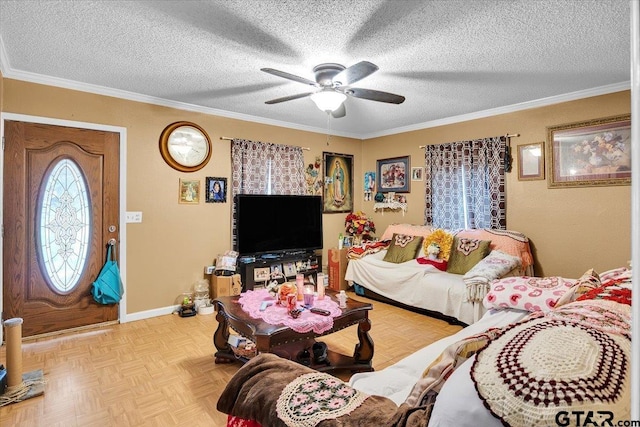 living area with a ceiling fan, baseboards, ornamental molding, and a textured ceiling