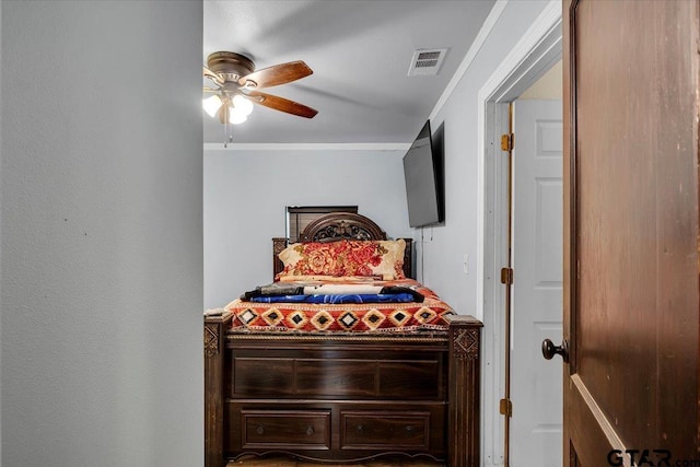 bedroom featuring ceiling fan, visible vents, and crown molding