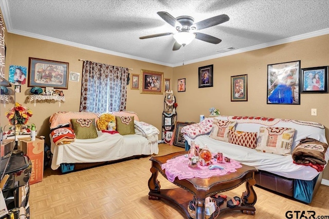 living room with ceiling fan, visible vents, a textured ceiling, and ornamental molding